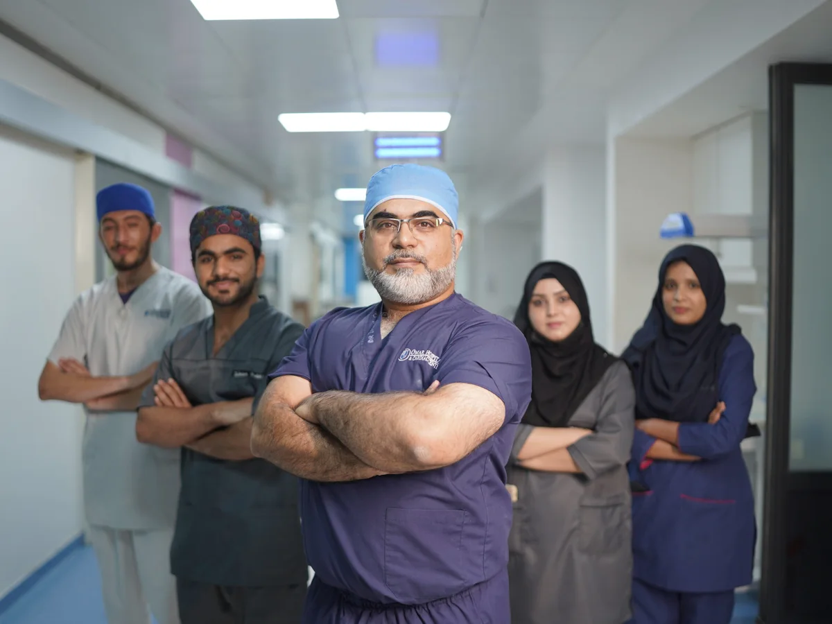 Dr Imran Salim Malik with his team in the hospital corridor